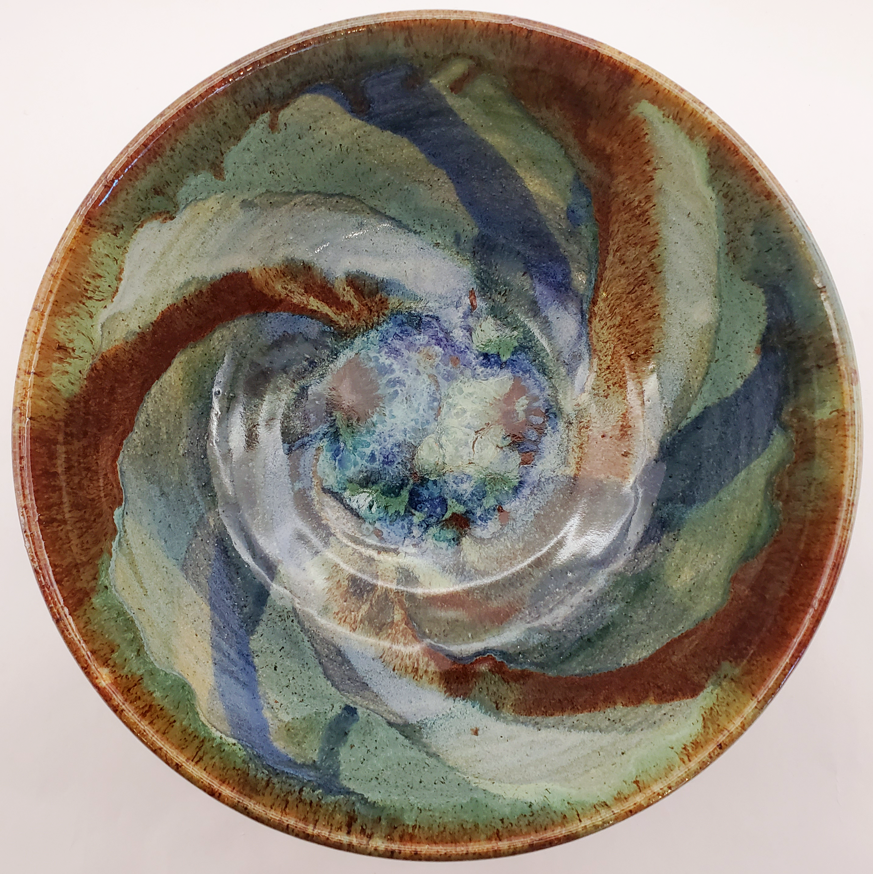 Beautiful bowls glazed with a galaxy swirl in blues, greens, yellows, browns, and reds. Handmade on Vashon Island by Abraham McBride Pottery. Local ceramics artist, Seattle Washington.