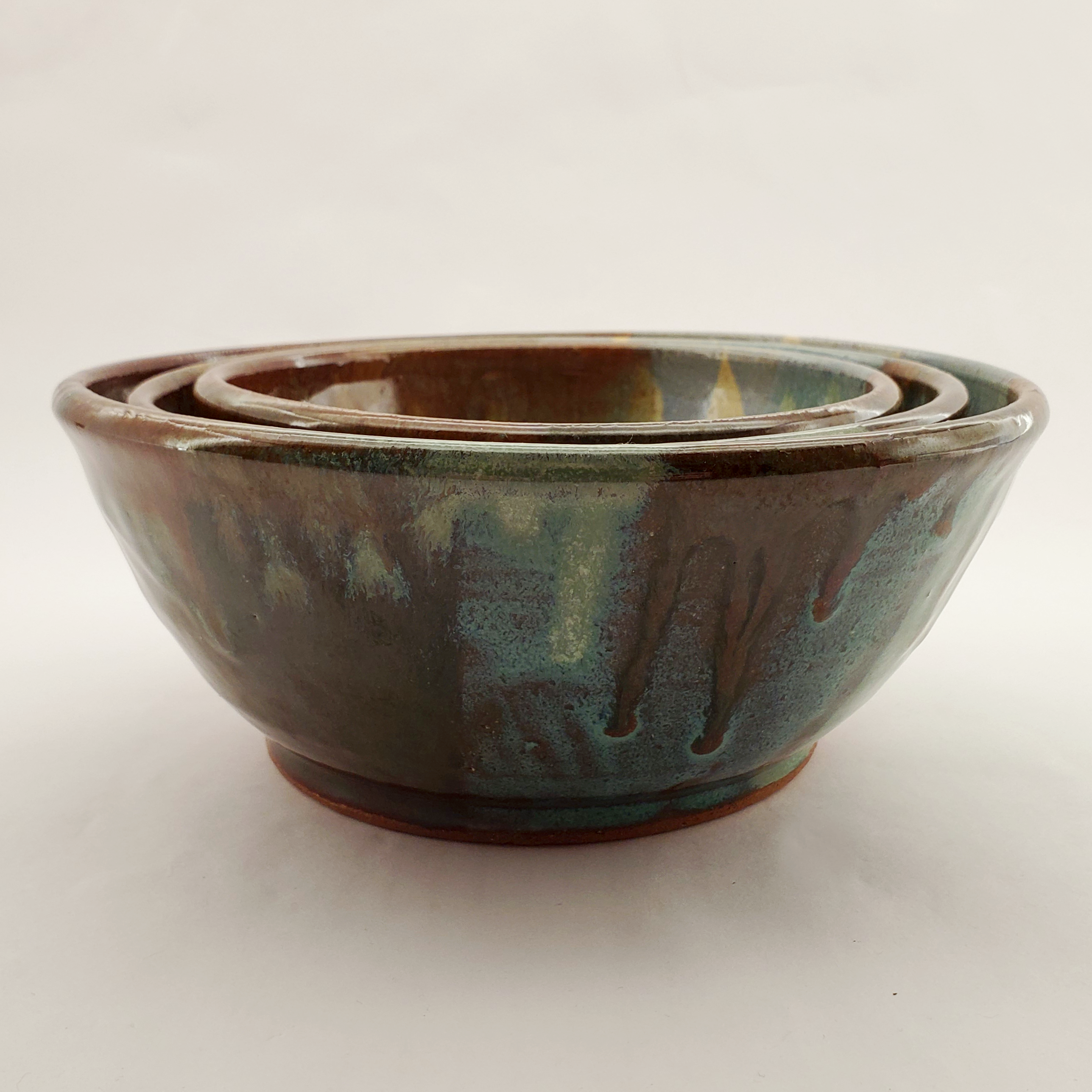Beautiful set of nesting bowls glazed in earthy tones and colors. Handmade on Vashon Island by Abraham McBride Pottery. Local ceramics artist, Seattle Washington.