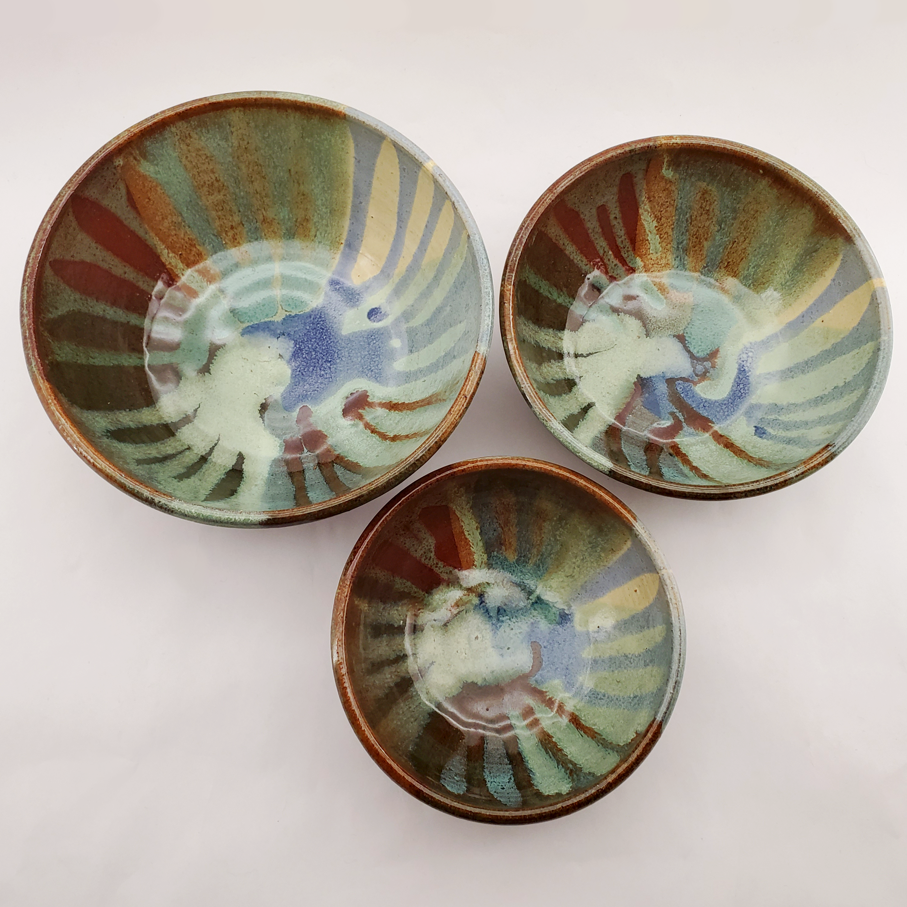 Beautiful set of nesting bowls glazed in earthy tones and colors. Handmade on Vashon Island by Abraham McBride Pottery. Local ceramics artist, Seattle Washington.